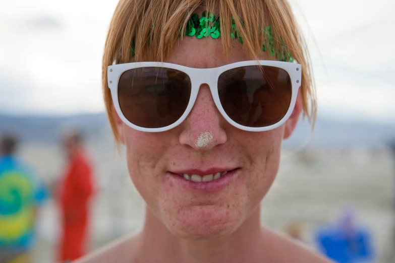 a woman in sunglasses with green hair and 