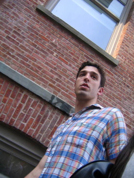 a man looking away from a building on a street