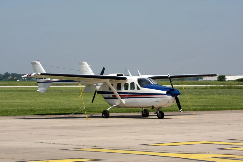 an airplane that is on a runway near grass