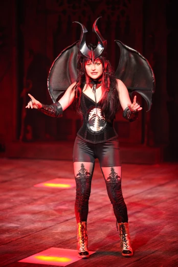 a woman in a costume standing with two hands up