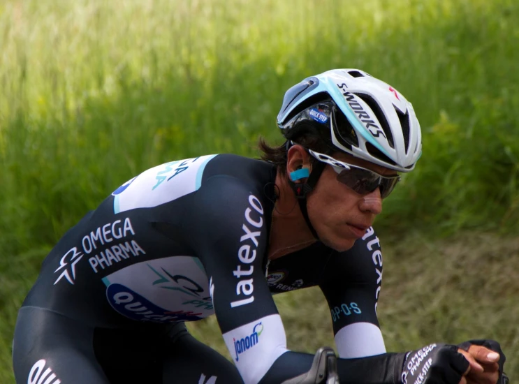 an olympic bicyclist looks down from his race run