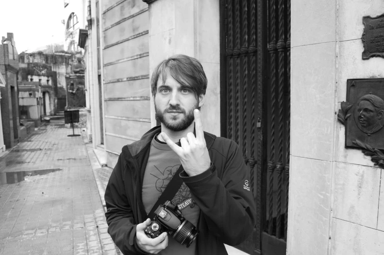 a black and white po of a person pointing at the camera