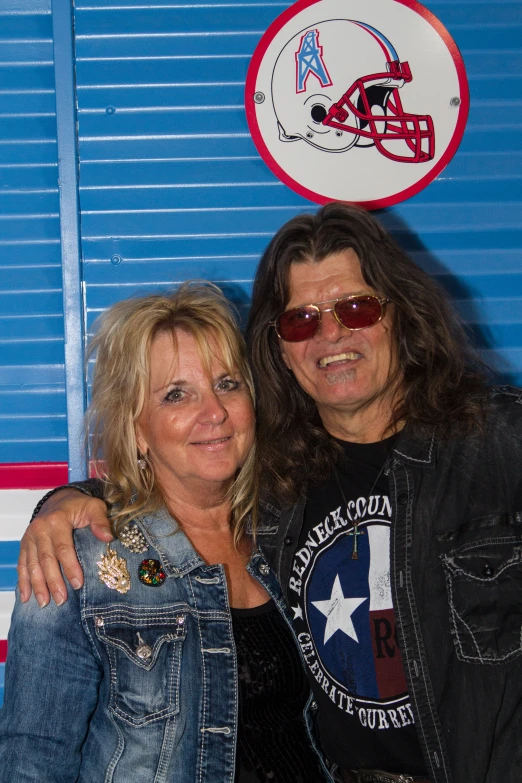 a woman and man wearing sunglasses posing for the camera