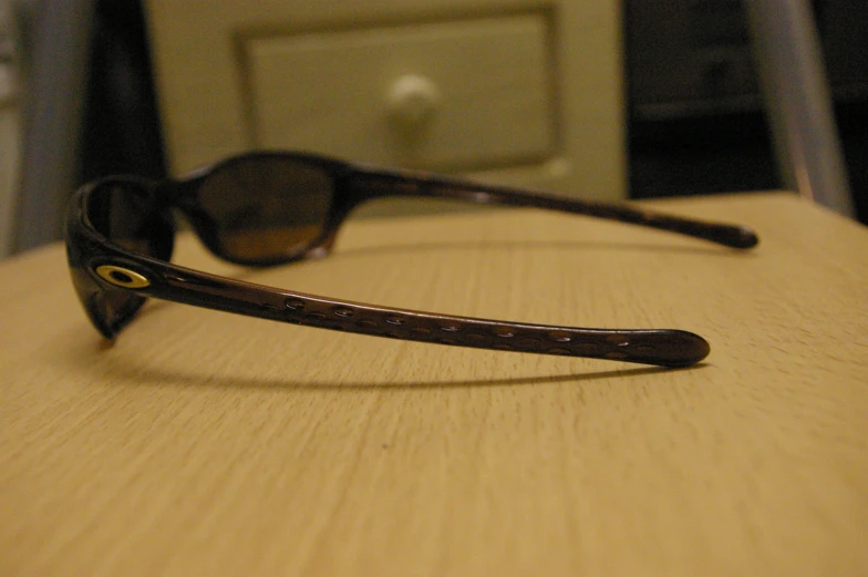 a pair of glasses sitting on top of a wooden table