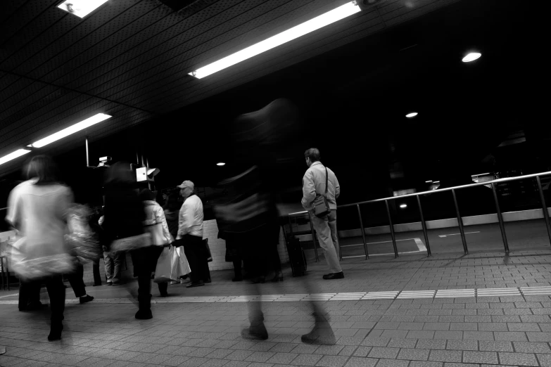 a black and white po of people walking in the street