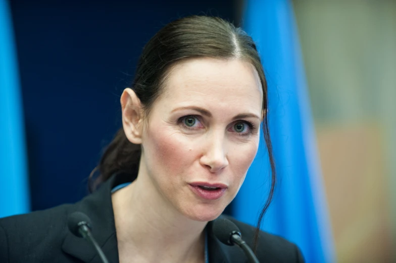 a woman giving a speech with a microphone in front of her