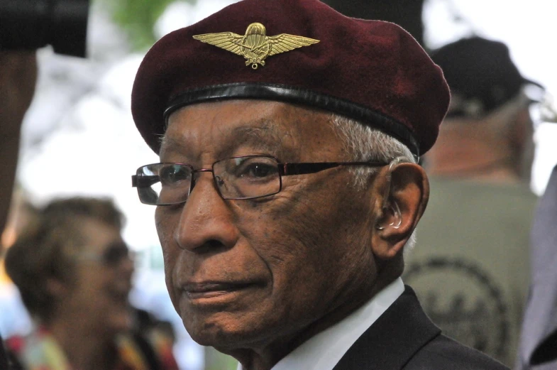 an older gentleman wearing a hat and glasses