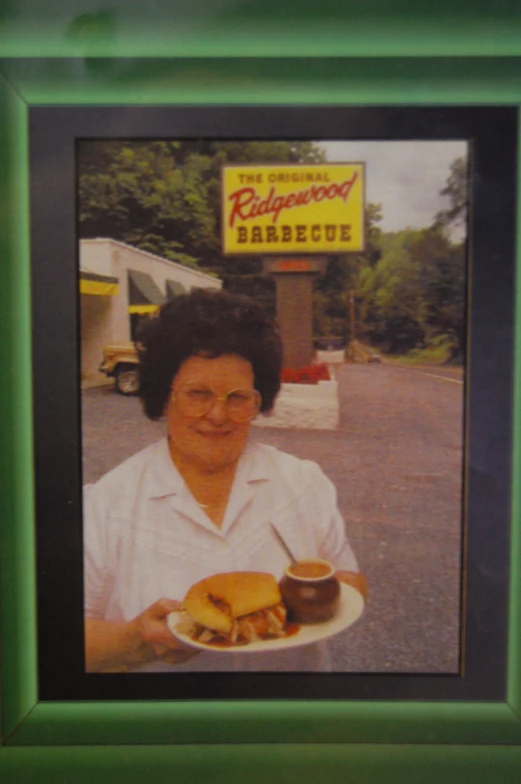 a woman holding a plate of food next to a coffee cup