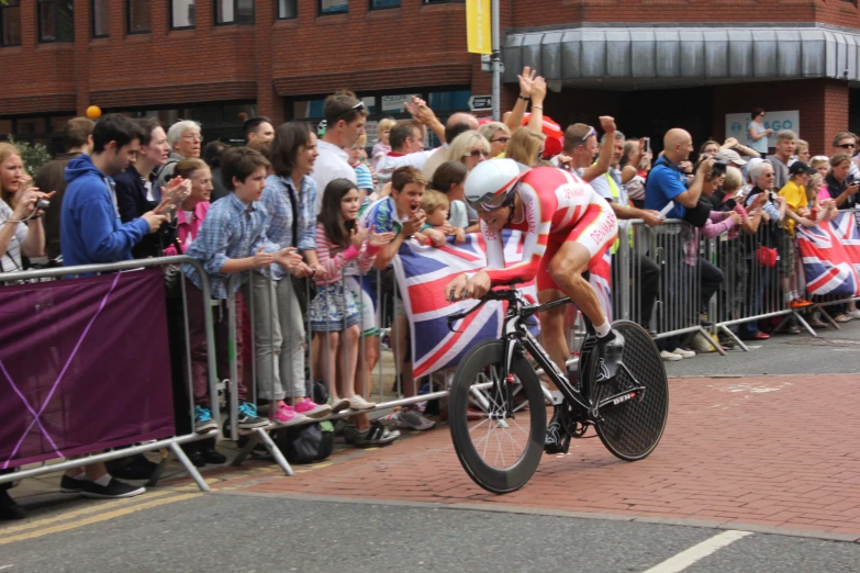 a man riding a bike while holding up flags