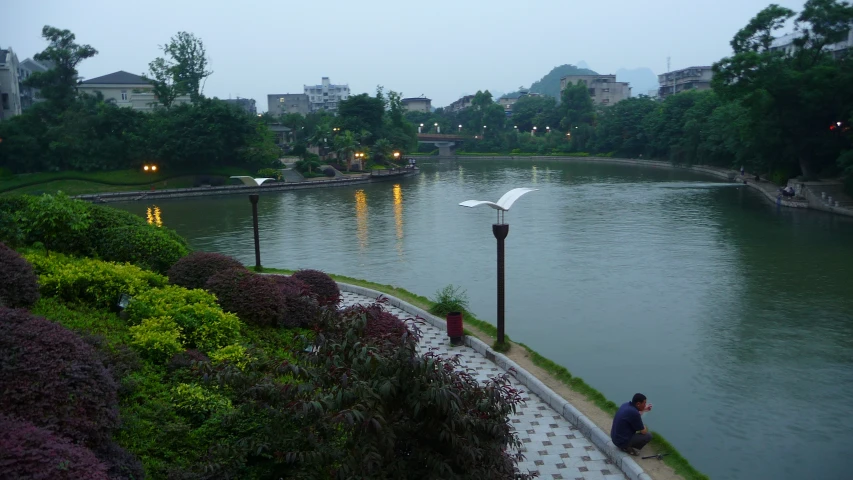 a view of an outside area with people near water