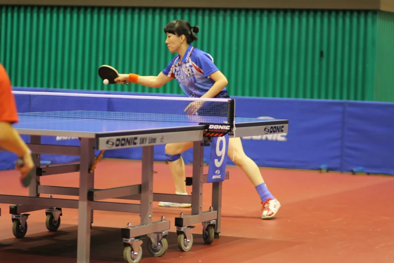 a woman on a court playing ping pong