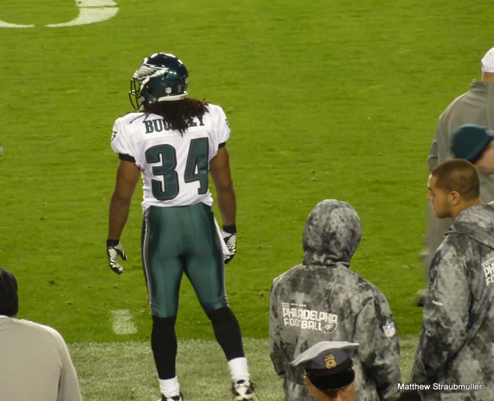 a professional football player is standing on the field