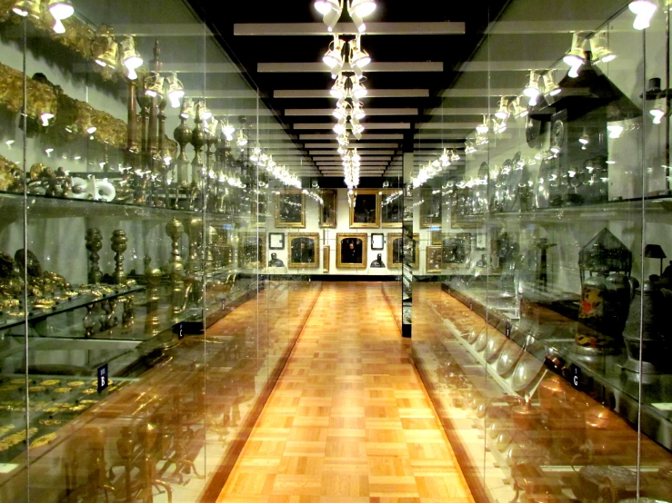 there is an empty hall with glass shelves full of items