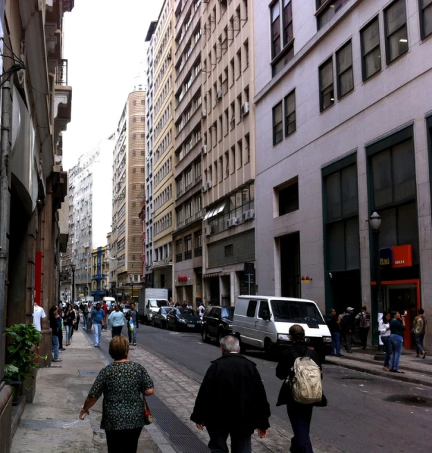 people walking down a street in a city