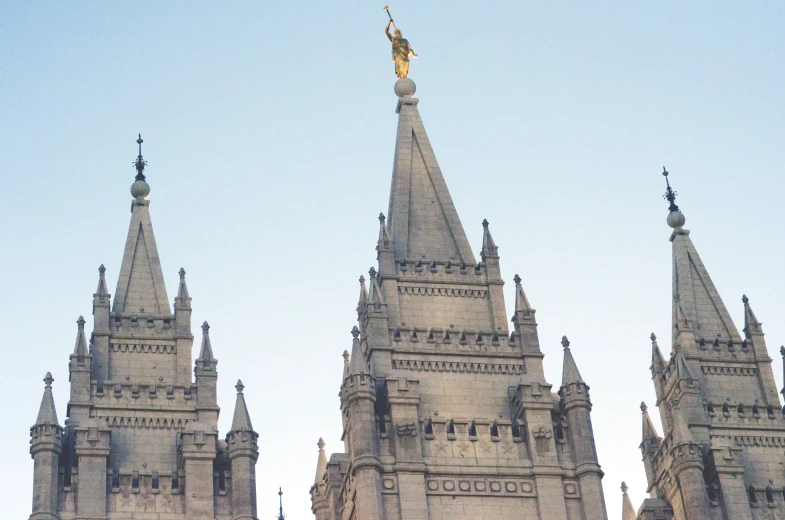 a tall tower with a gold figure atop