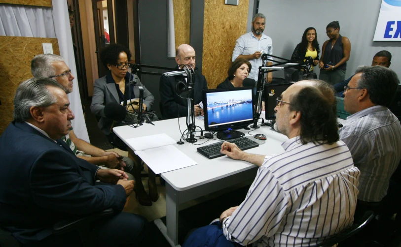 an image of a group of people in front of a computer