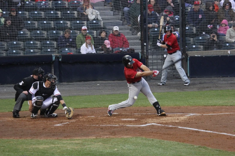 there is a man in red jersey and a baseball player on a field