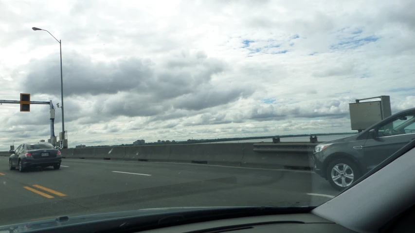 the cars are traveling across the bridge on the highway