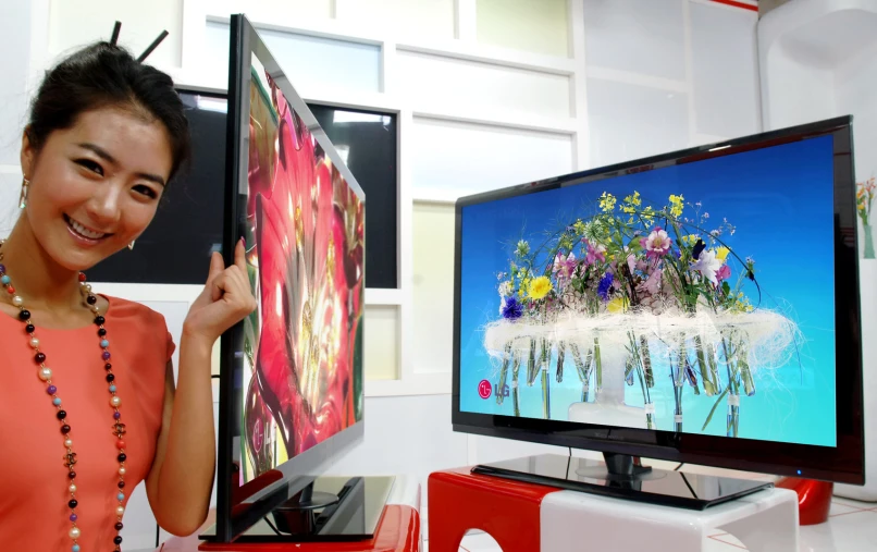 a woman is standing next to a tv