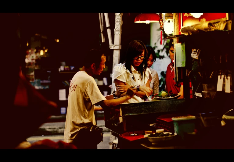 a woman  food in front of a man in the street