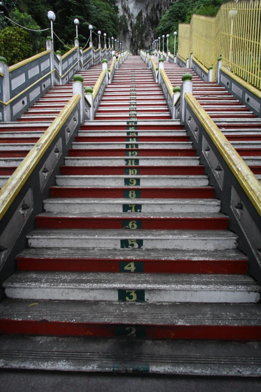 many red steps that lead up to a big rock