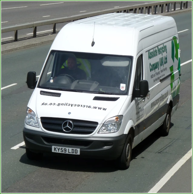 white mercedes benz vans drives on a roadway