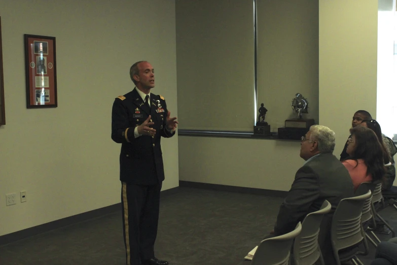 two men in uniform standing next to each other near chairs