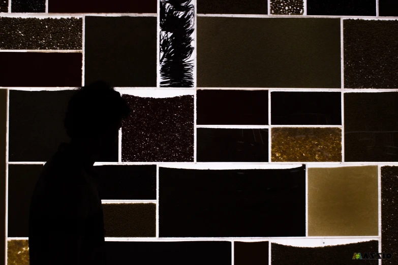 a man with a hat standing in front of lots of random materials