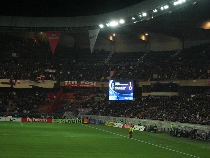 the stadium is full of soccer fans and there are people watching