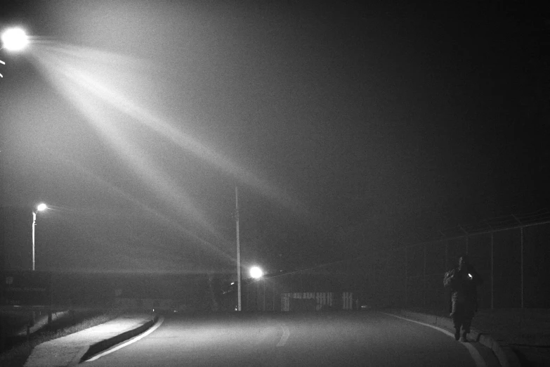 a man on the street at night holding a flashlight