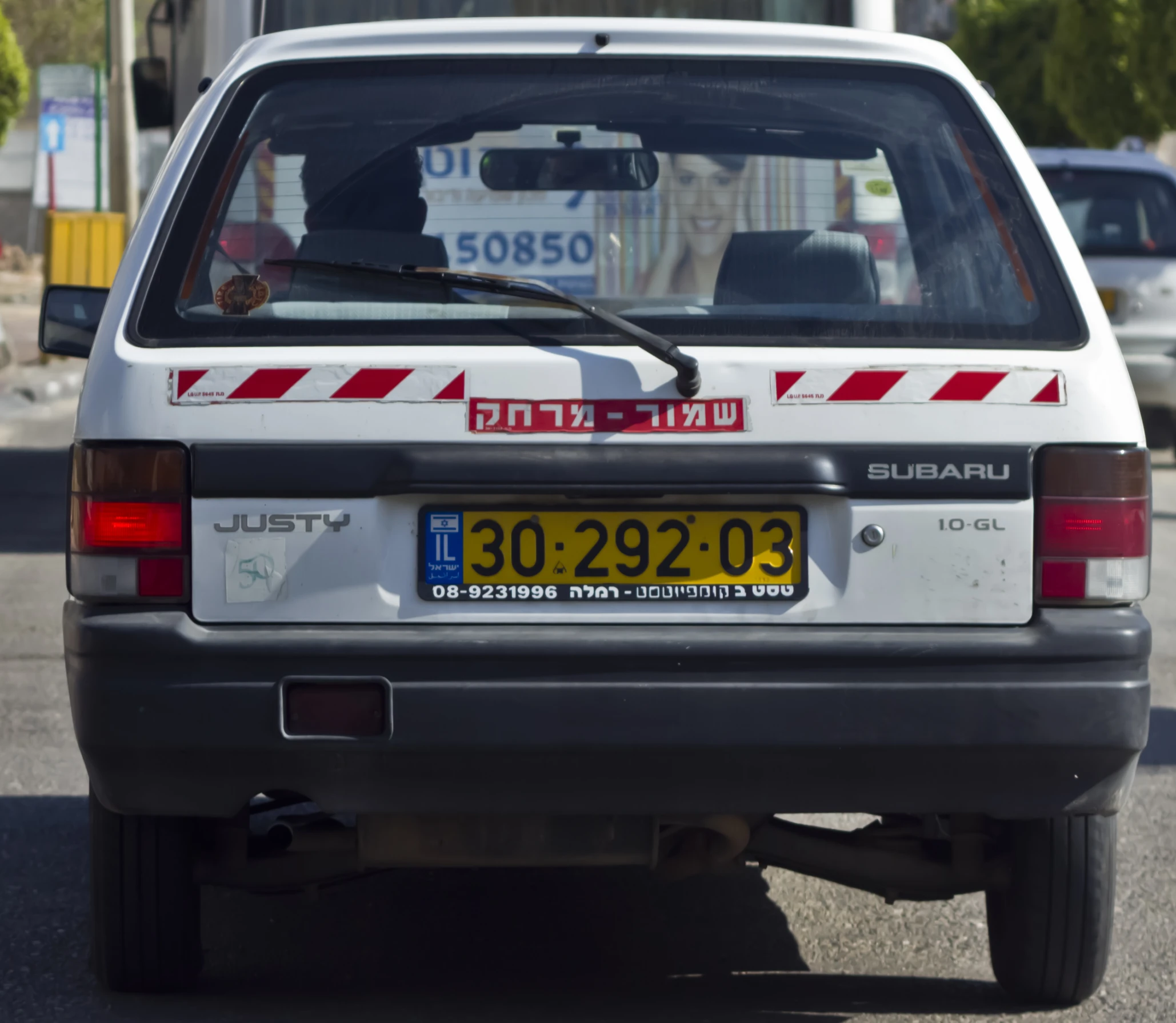 an suv is driving in the street with its door open