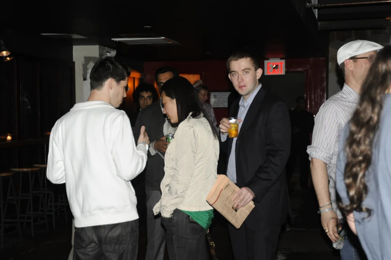 group of people standing near each other in a room