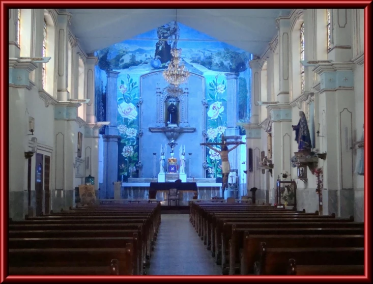 a church with a blue ceiling has pews