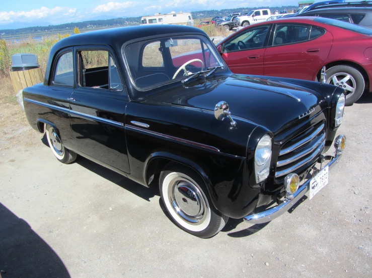 old fashioned black truck with white wheels parked