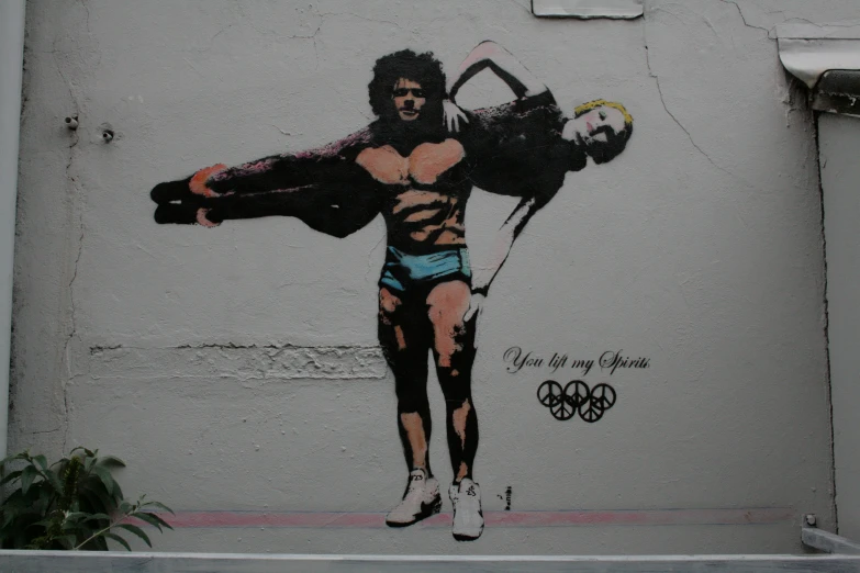 a man painted on a building and wearing underwear