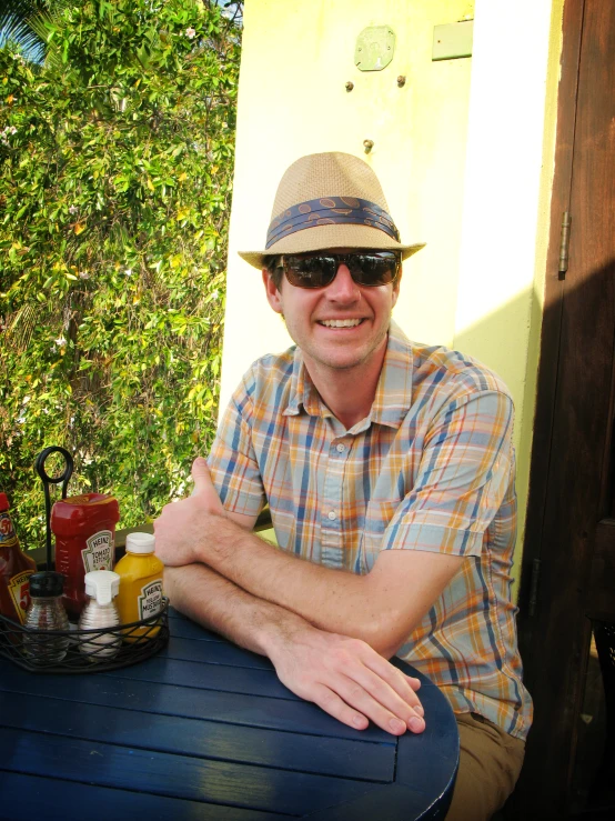 a man sitting at a table with food in front of him