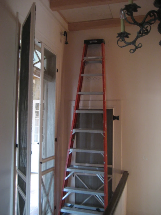 a ladder that is in the wall by a window