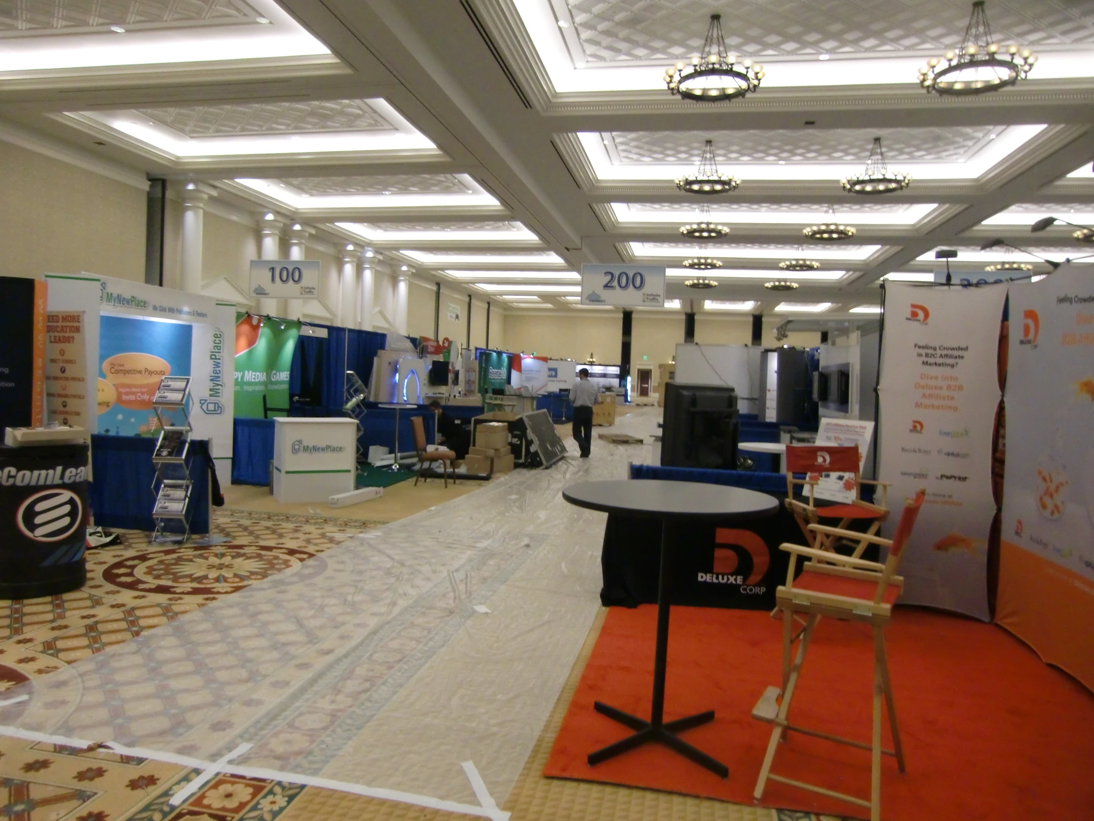 an empty convention hall with many signs and decorations