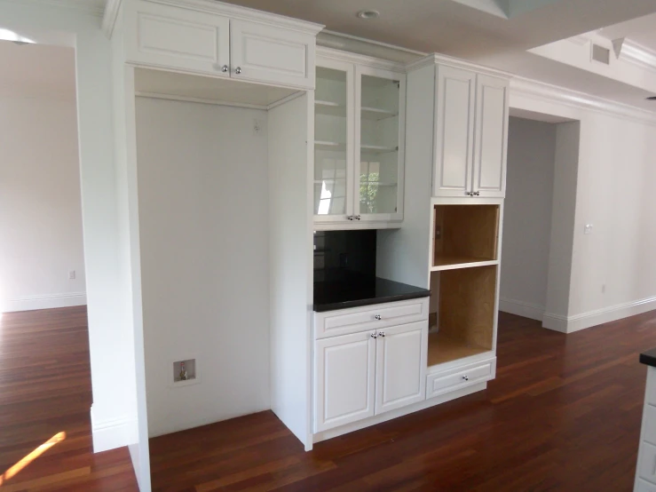 the pantry is white and is kept organized