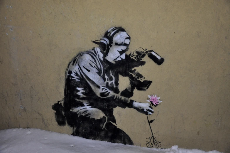 a graffit of a man with flowers next to a wall