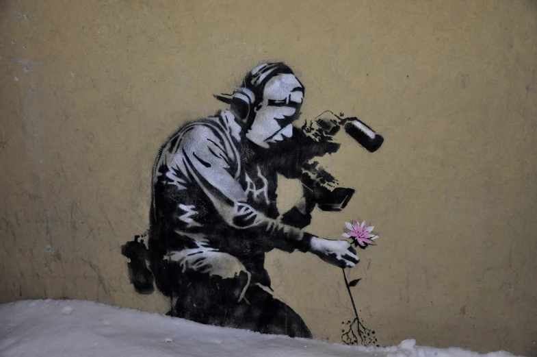 a graffit of a man with flowers next to a wall