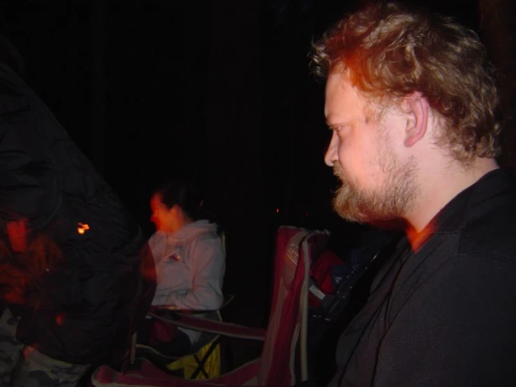 people sitting at a table with food near one another