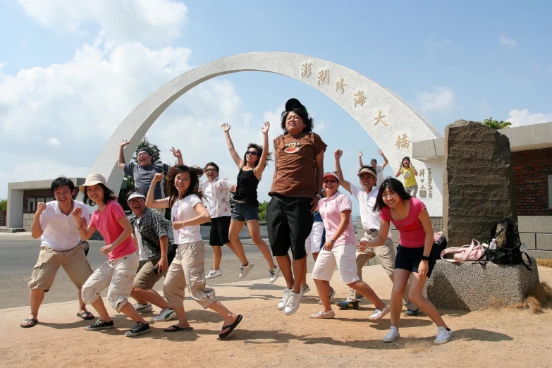 a group of people holding hands up and posing for a po