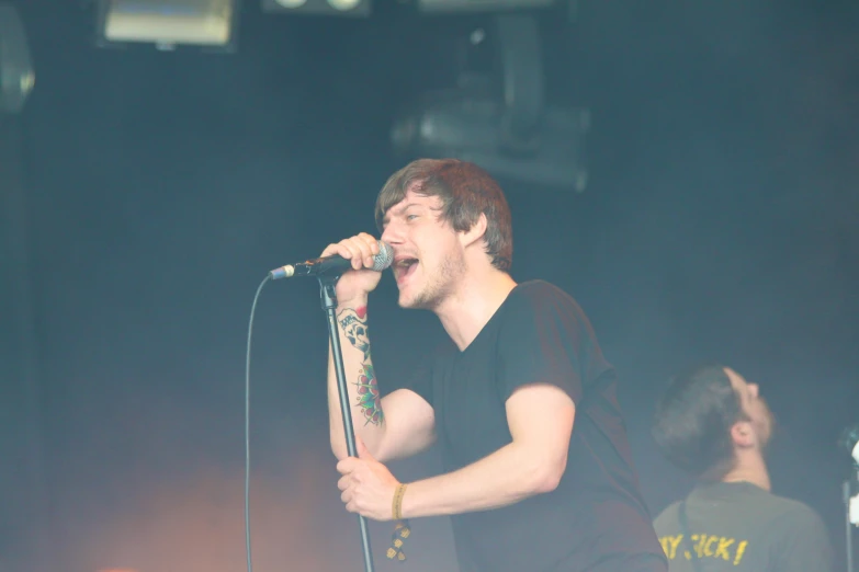 a young male is singing into a microphone