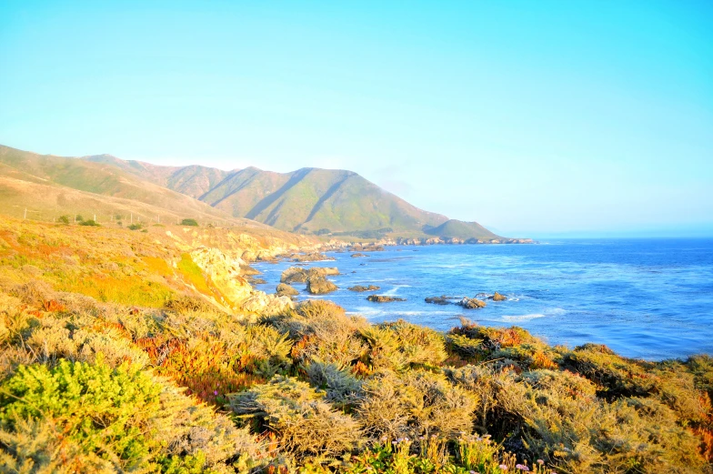 a view of an ocean on a hill with hills on either side