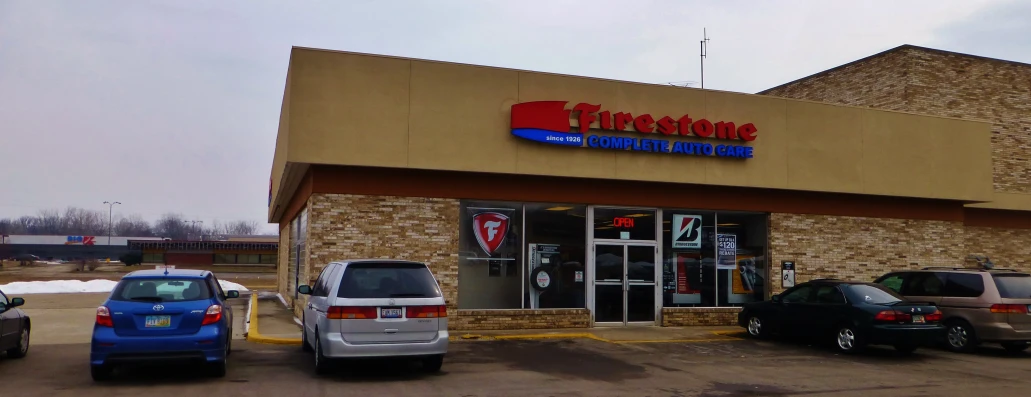 cars parked outside of a store called vitastorre