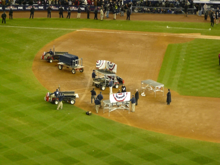 several vehicles parked on a baseball field