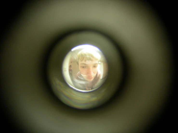 a round mirror with a woman in it