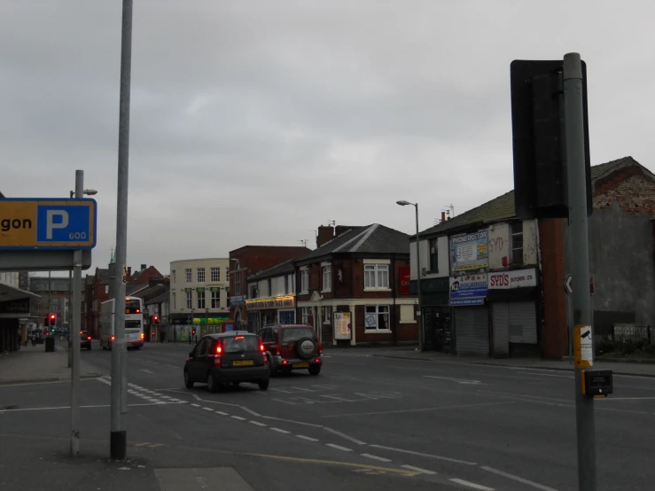 a street scene with a parking meter and some cars