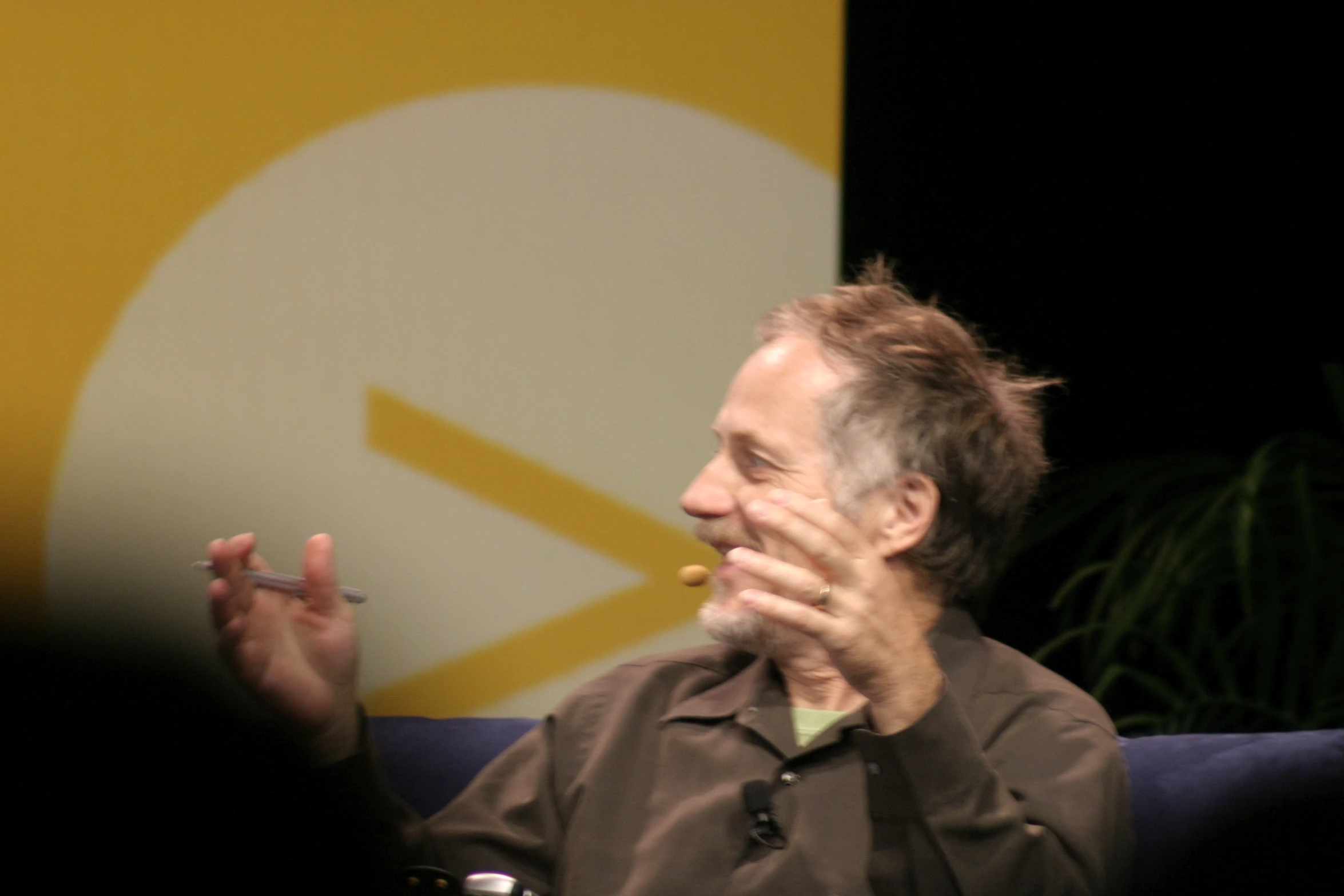 an older man smoking a cigarette on a couch